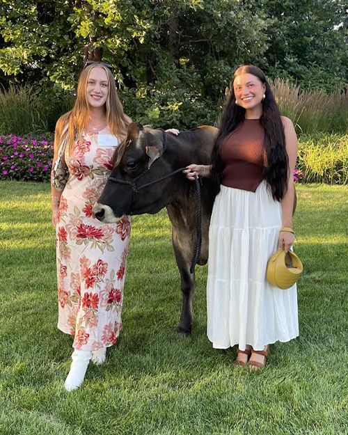 liv upstone and stormy beauchamp with a cute dairy cow